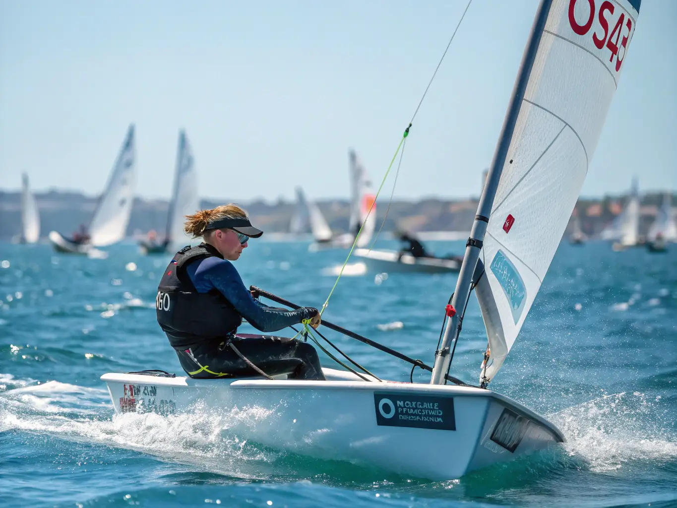 A photograph of experienced sailors participating in an advanced sailing course, navigating a larger sailboat through choppy waters with focused determination. The image highlights skill development and challenge.