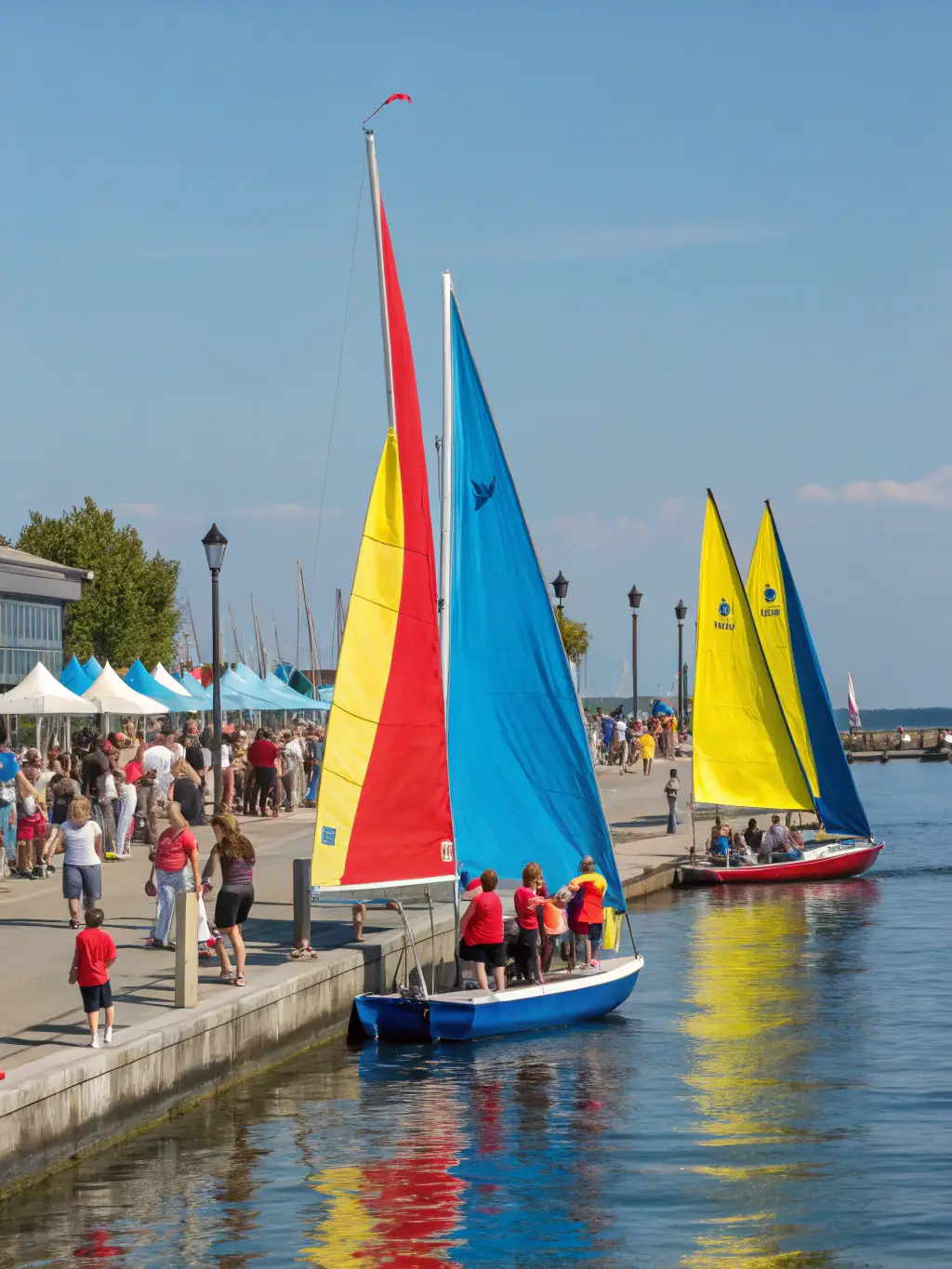 A group of young sailors participating in a friendly race, promoting teamwork and competitive spirit in a supportive environment.